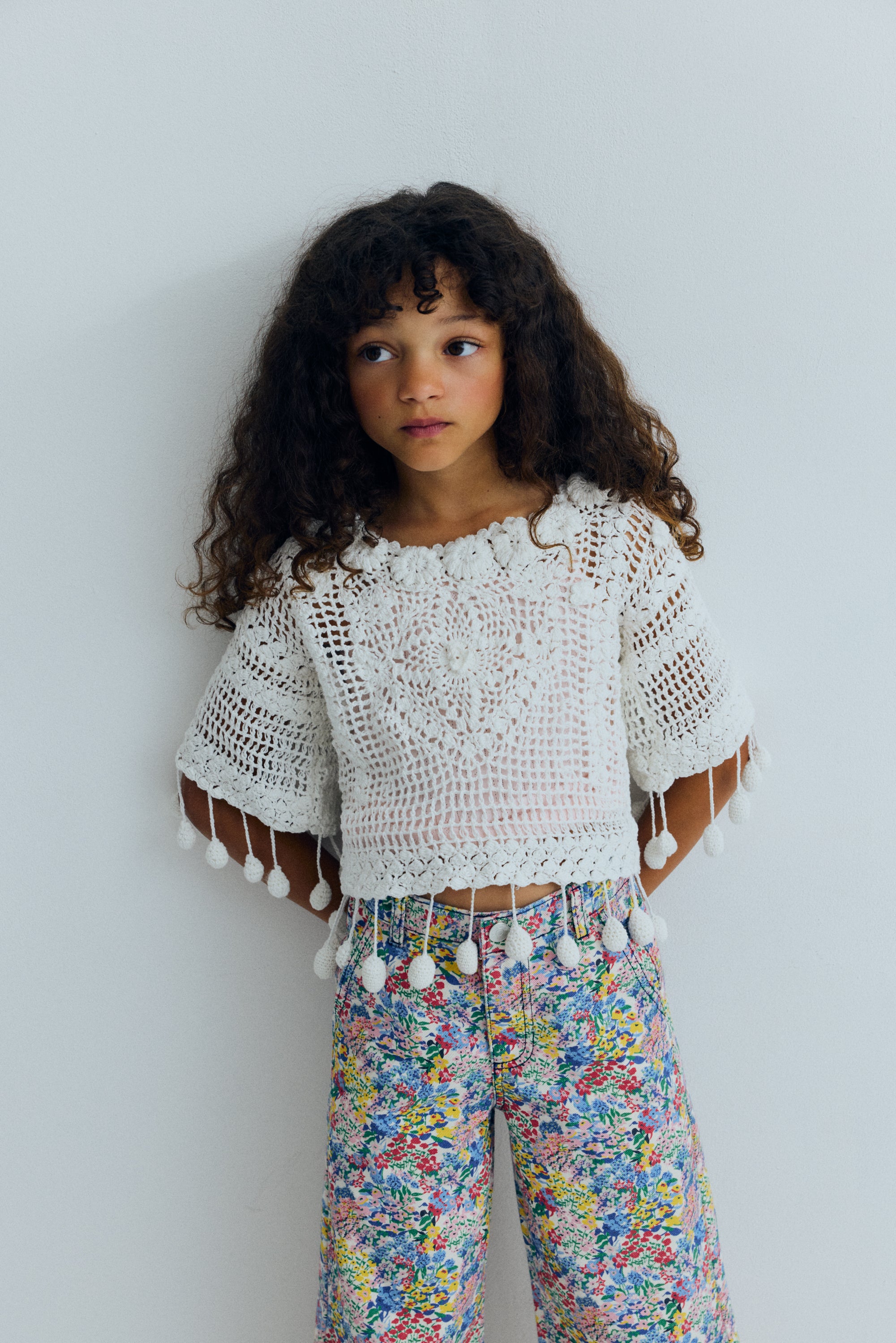 Wide leg denim pants featuring a beautiful flower print, straight legs, and an adjustable waistband with interior elastic