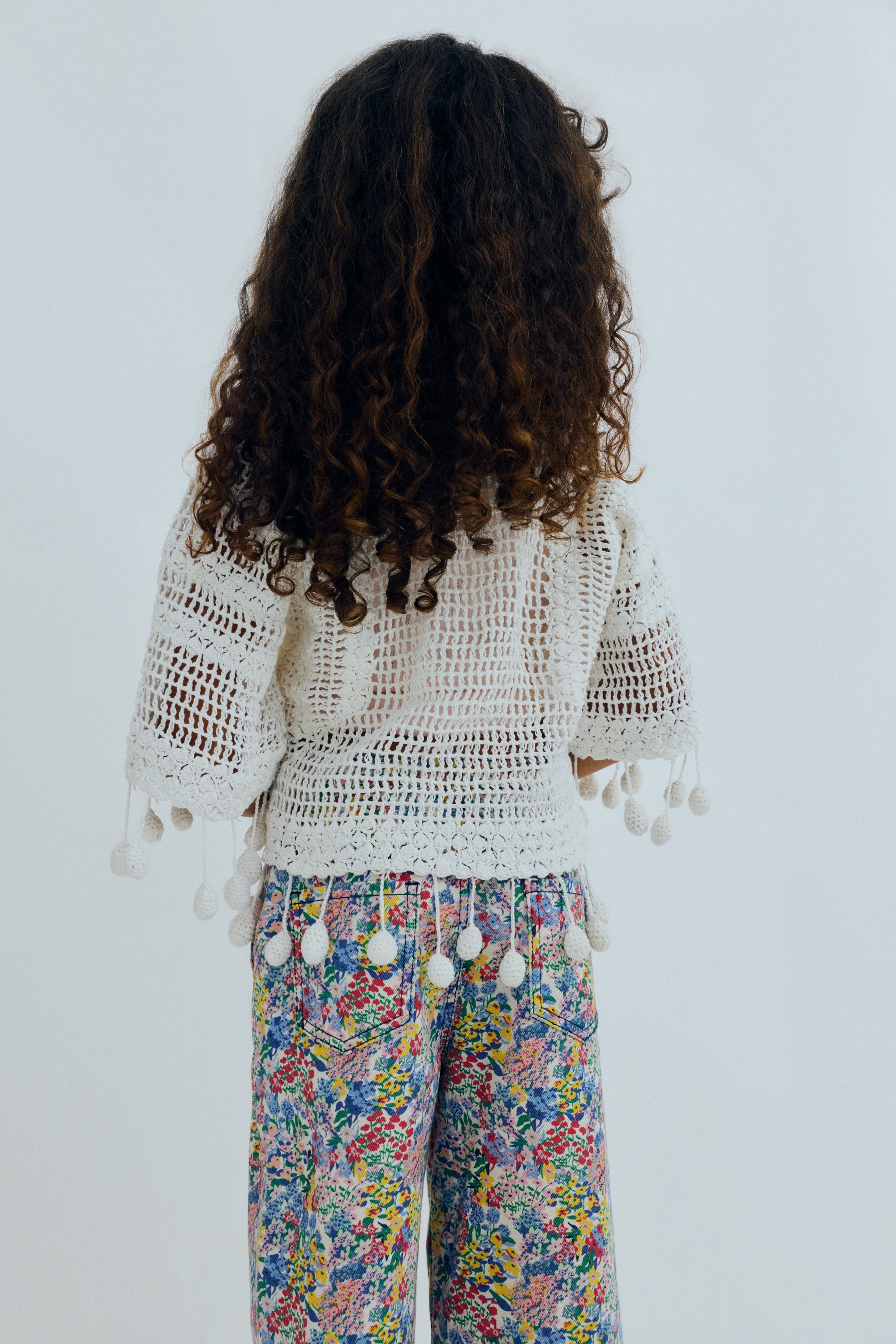 Wide leg denim pants featuring a beautiful flower print, straight legs, and an adjustable waistband with interior elastic