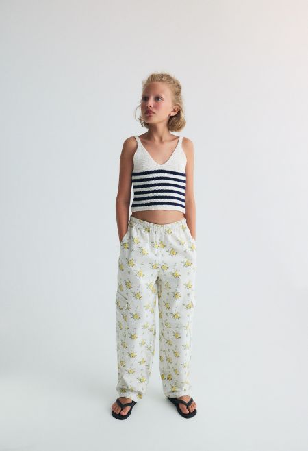 Crop knit top with a V neckline and thin straps, featuring two color nautical style stripes for a fresh, summery feel
