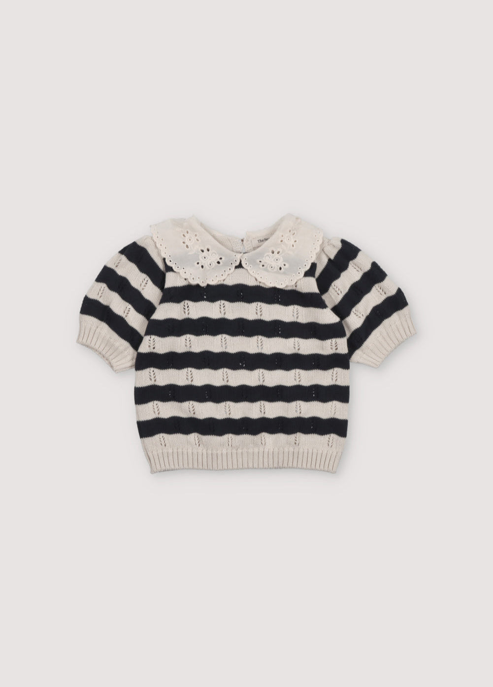 Bicolor striped short-sleeved knit sweater with delicate contrast lace collar detail. It features elastic ribbing at the hem and also elastic cuffs. It's a perfect garment to create a fun total look with the matching pants. The New Society. Spring Summer Collection.