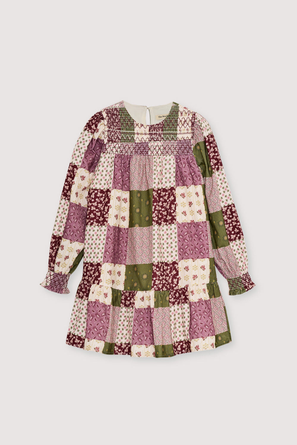 This charming dress features a unique patchwork print, puffed sleeves, and a ruffled skirt.