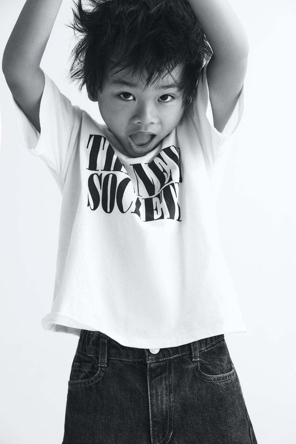 The Moonlight White T-shirt features a bold contrasting "The New Society" logo, designed for a clean and modern look