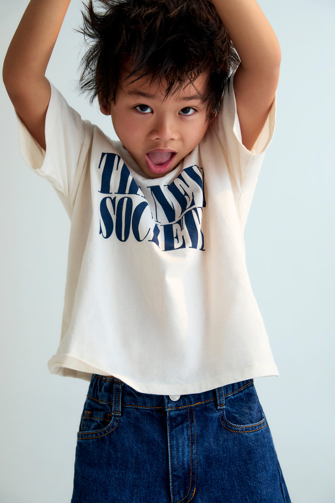 The Moonlight White T-shirt features a bold contrasting "The New Society" logo, designed for a clean and modern look