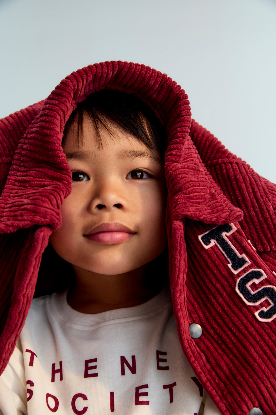 This corduroy bomber jacket in Plum Fantasy features ribbed cuffs and hem in a matching tone for a clean, cohesive look