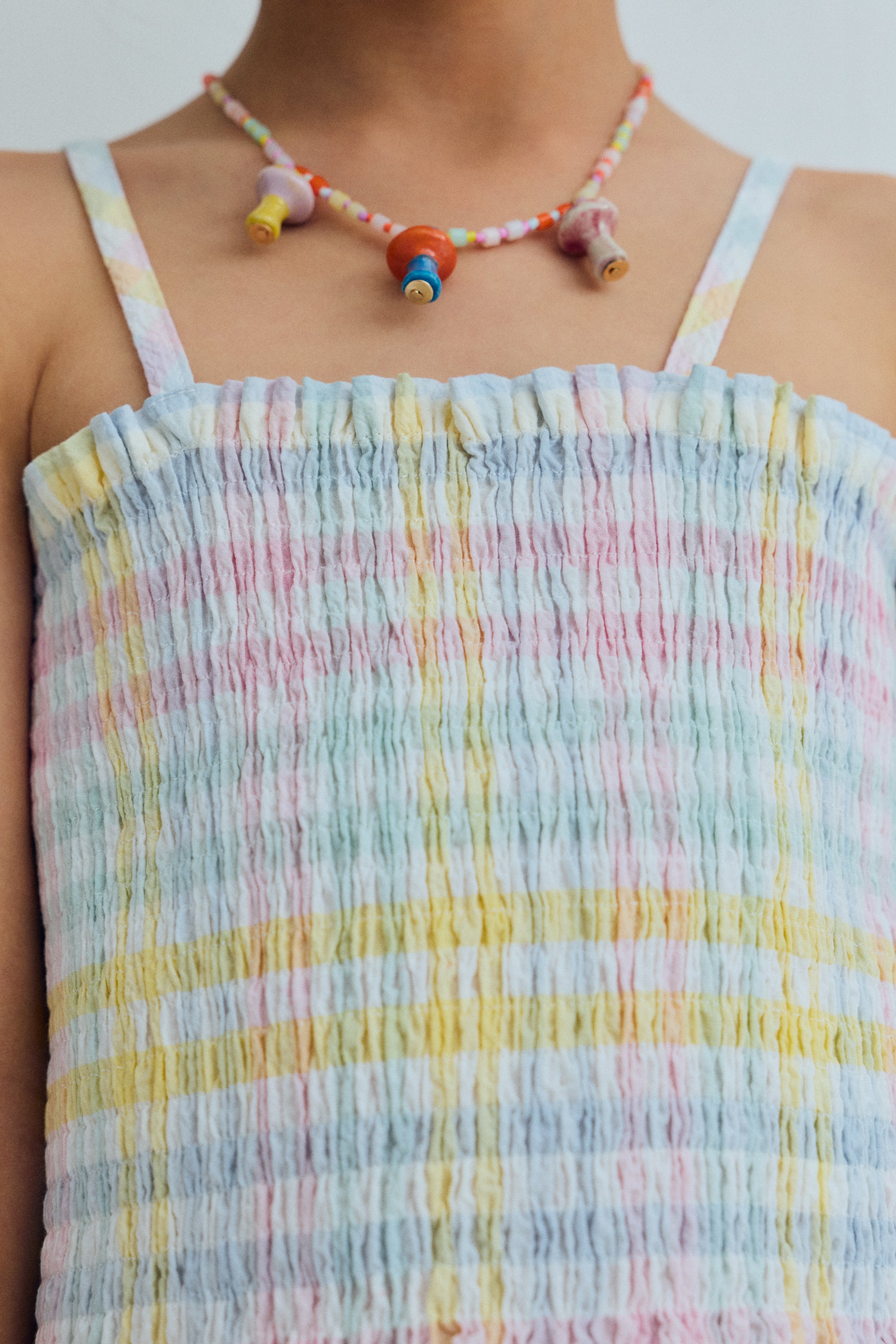 Top in cotton seersucker with multicolor checks, featuring all over smocking that creates a comfortable and flattering fit