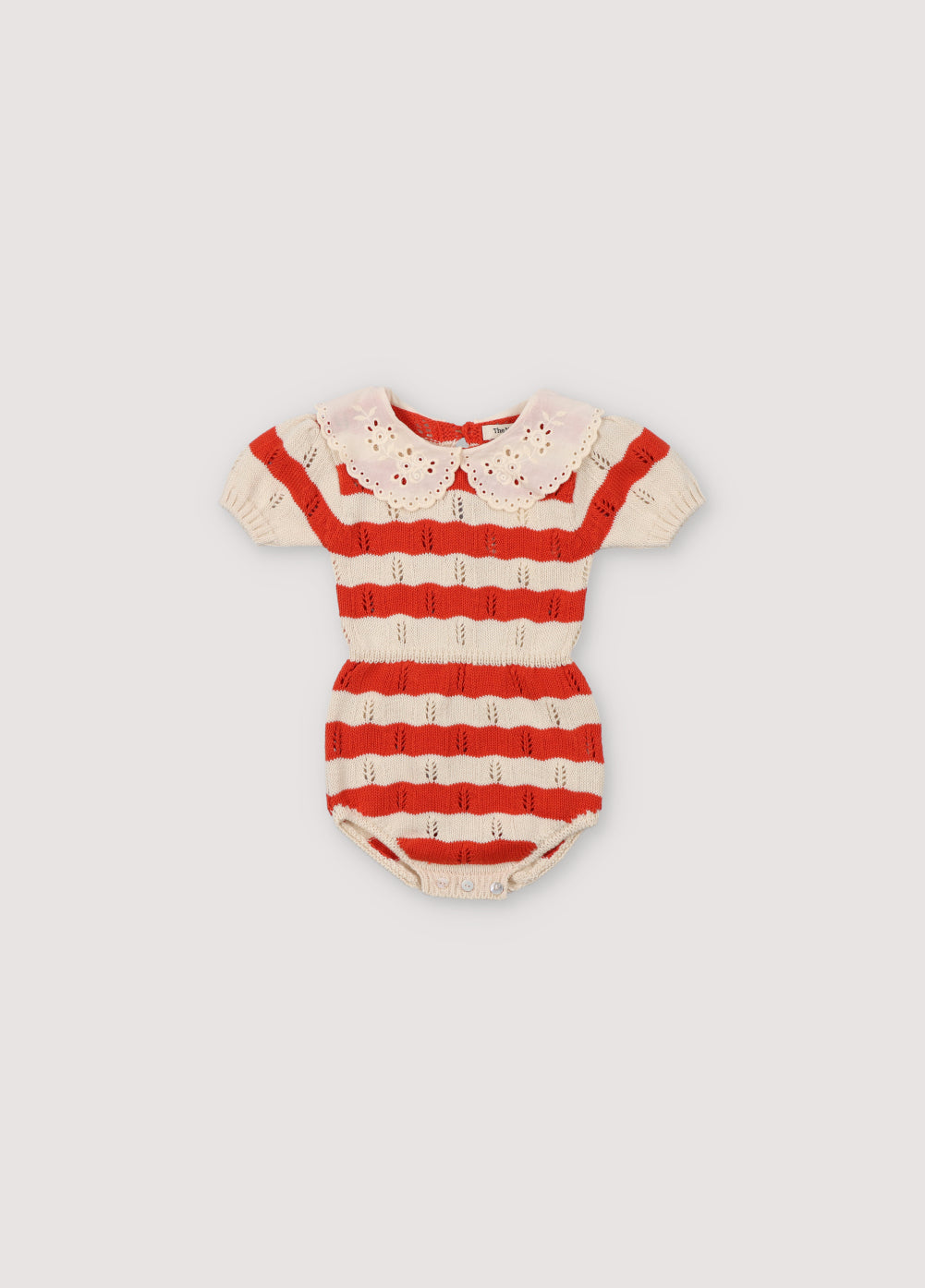 Bicolor striped romper with contrast lace collar detail. It has elastic waistband and cuffs, and an opening with snaps and back with placket and mother-of-pearl buttons. Spirng Summer Collection. The New Society.