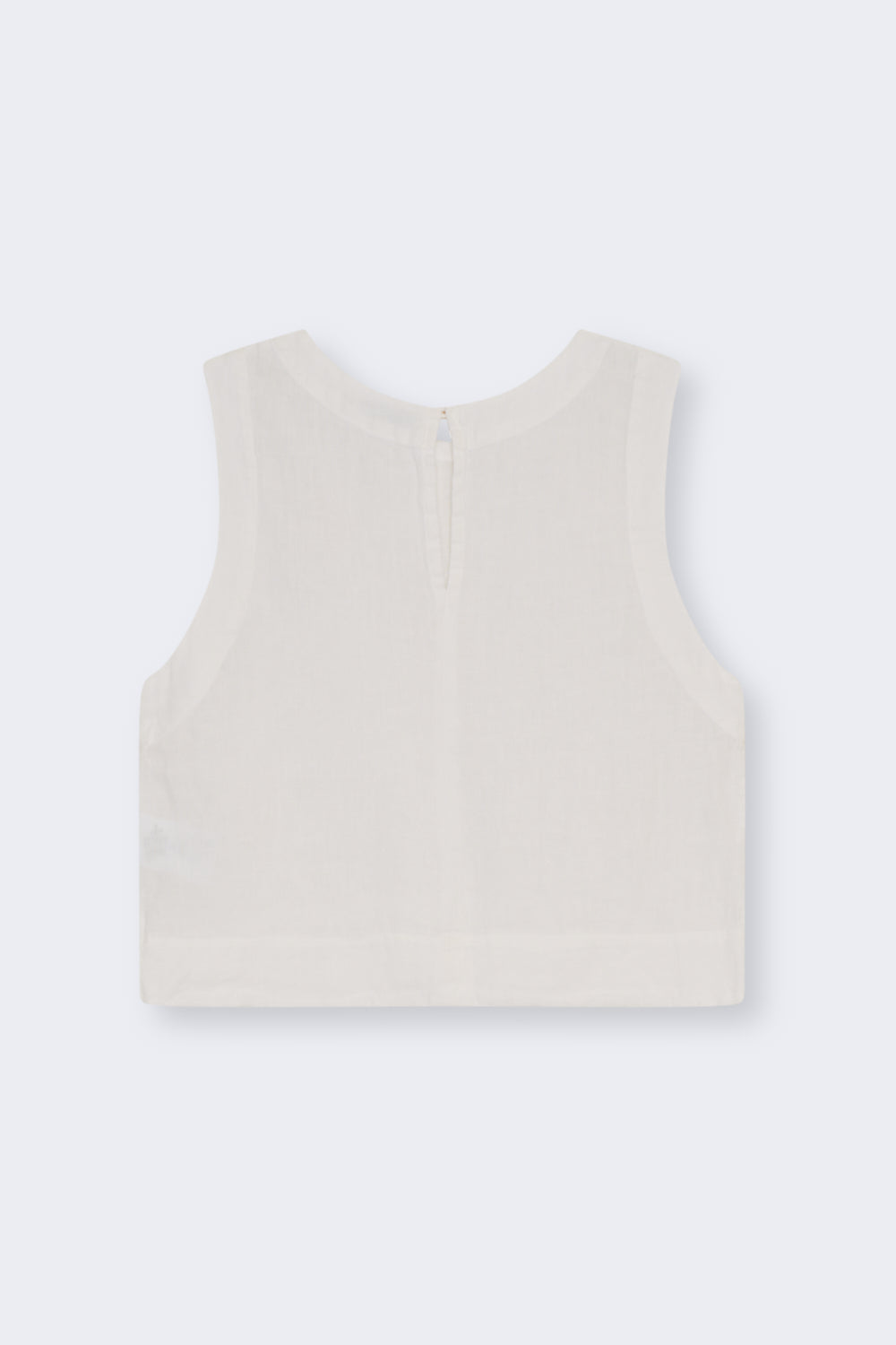 100% linen top made in Portugal with a soft and delicate finish. Features a back keyhole opening with a button closure