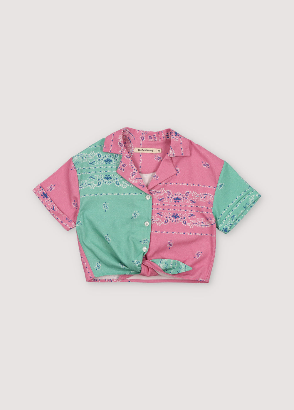 Mileto Girl Shirt in 100% cotton with our hibiscus and jade bandana prints. The shirt features print contrasts, a knot between the two colors at the hem, and white shirt buttons. Spring Summer Collection. The New Society.