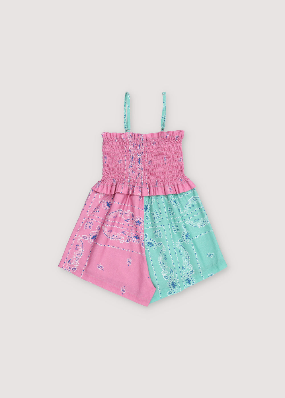 Mileto Jumpsuit in 100% cotton with our hibiscus jade bandana print. The jumpsuit features gathered straps, smocking on the upper part, and shorts combining hibiscus and jade prints. Spring Summer Collection. The New Society.