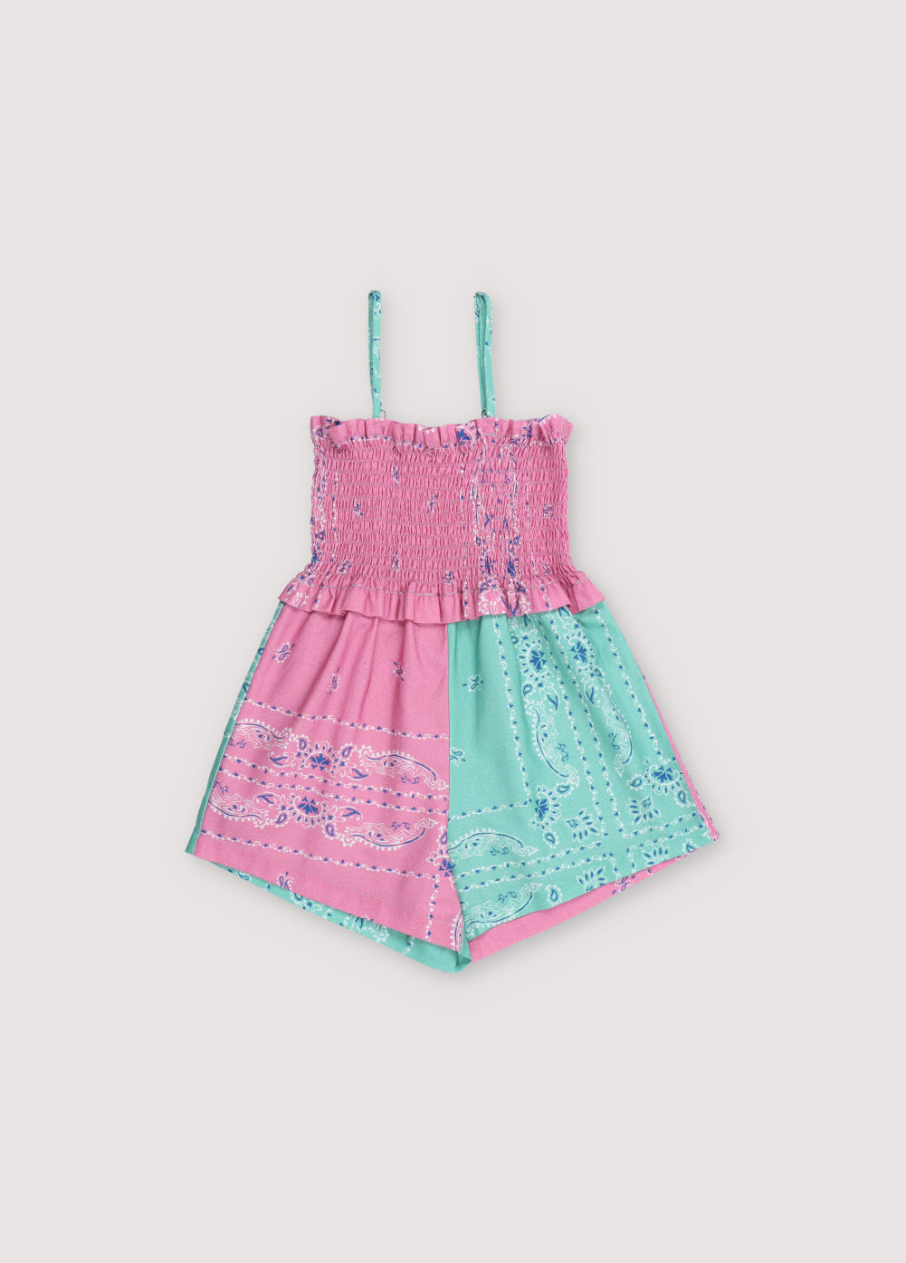 Mileto Jumpsuit in 100% cotton with our hibiscus jade bandana print. The jumpsuit features gathered straps, smocking on the upper part, and shorts combining hibiscus and jade prints. Spring Summer Collection. The New Society.