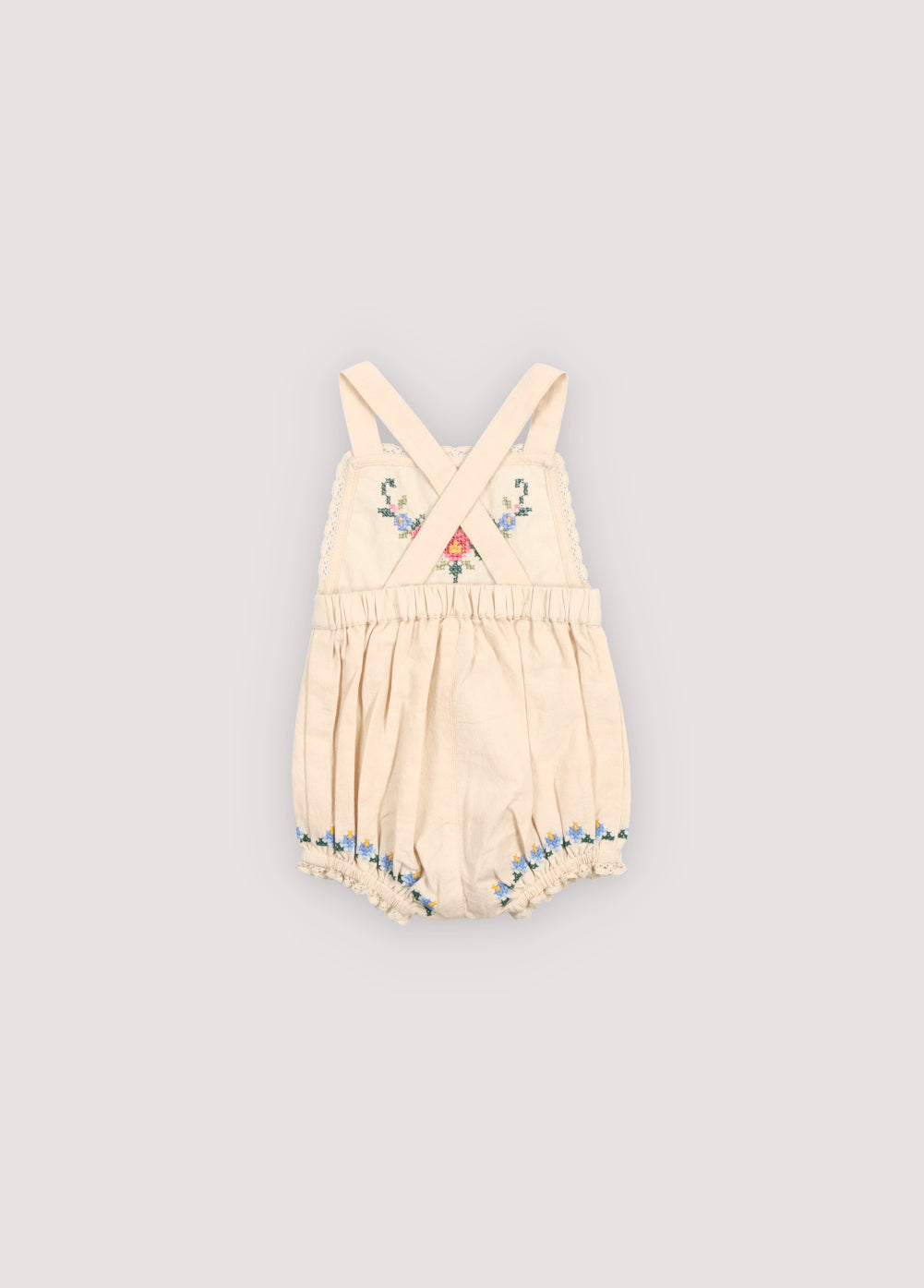 Crafted from soft cotton fabric, this romper features fine, delicate embroidery details on the front and hem.