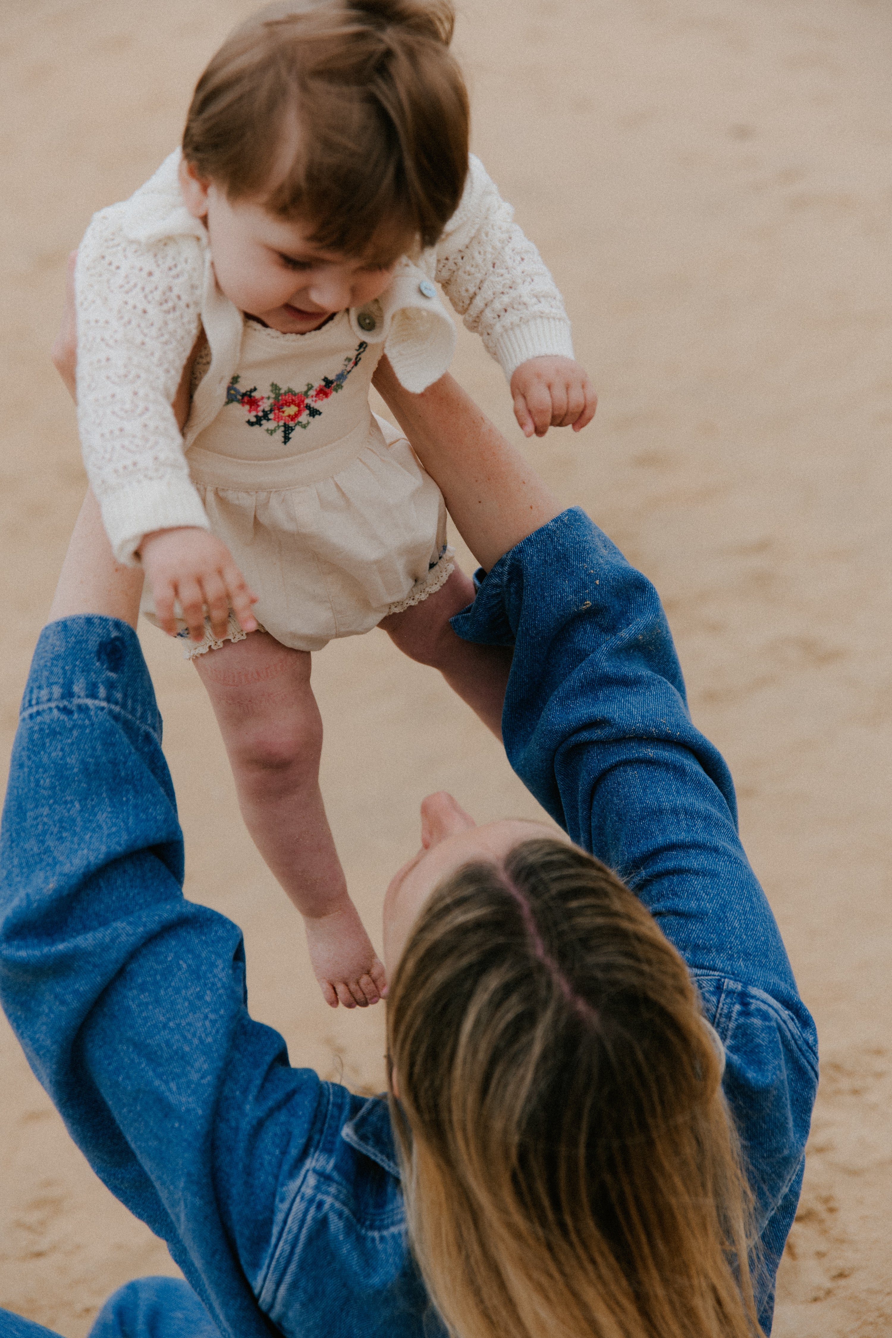 Crafted from soft cotton fabric, this romper features fine, delicate embroidery details on the front and hem.