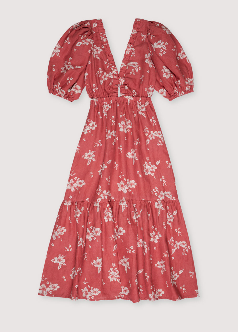 The V-neckline with an elastic band enhances the fit, while the puffed sleeves add a playful touch. The elastic waistband creates volume in the skirt, giving it a flattering and feminine silhouette