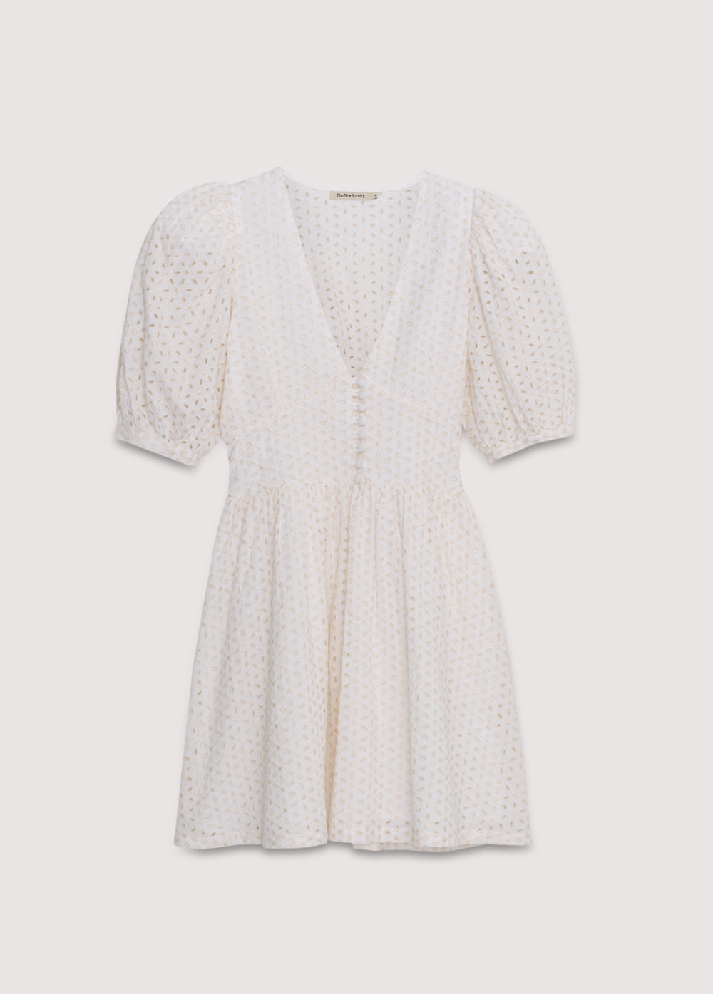 Nemesis Woman Dress in 100% cotton embroidered poplin. It features a V-neck, long billowy sleeves, and a fitted waist. It closes at the front with buttons covered in the same fabric. Spring Summer Collection. The New Society.