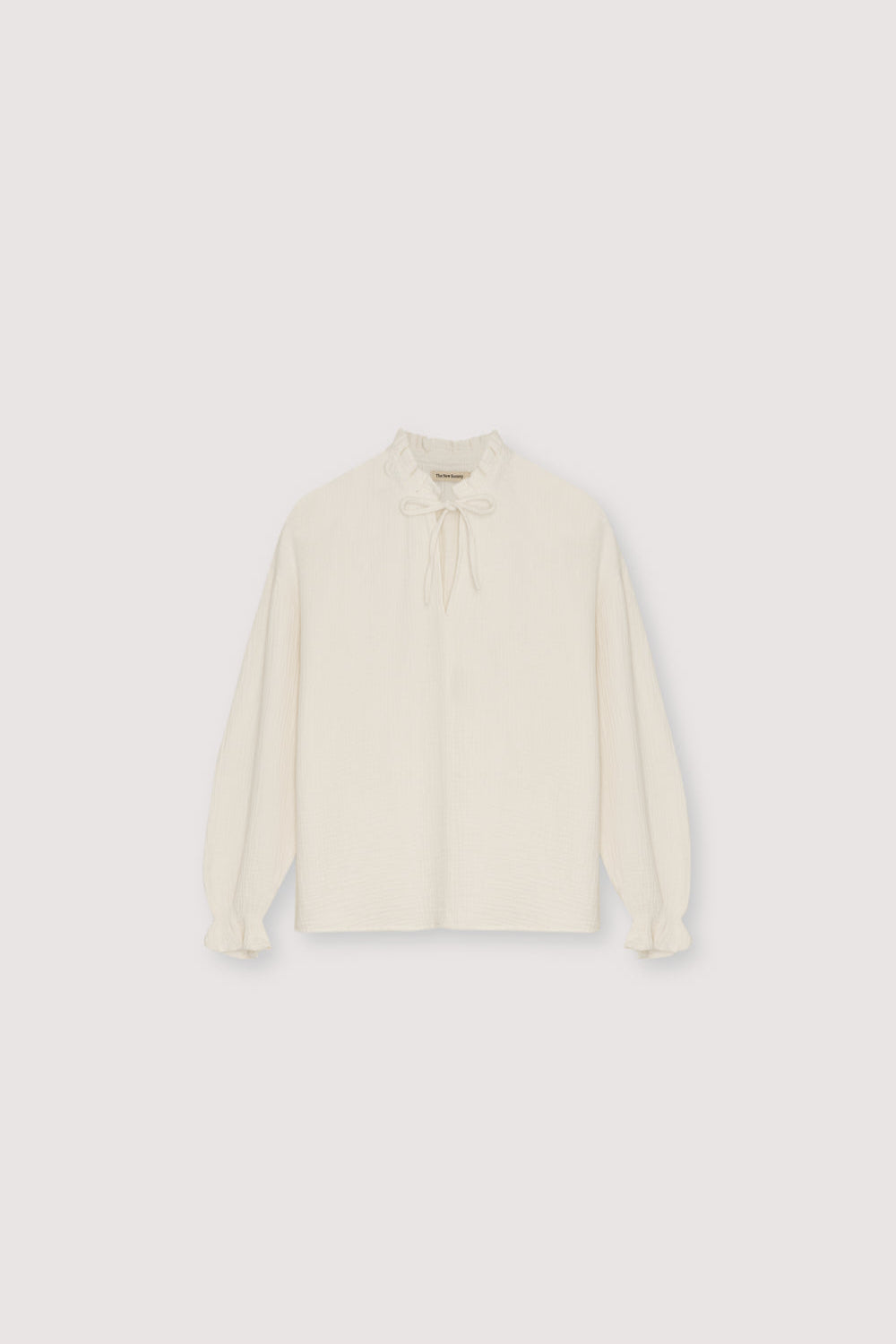 Our classic Olivia Blouse, made from double gauze fabric. It features puffed sleeves and a front keyhole detail with a tie.