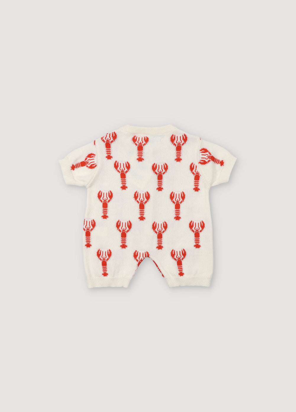 Romper with a fun lobster intarsia pattern and front opening with wooden buttons. Spring Summer Collection .The New Society.