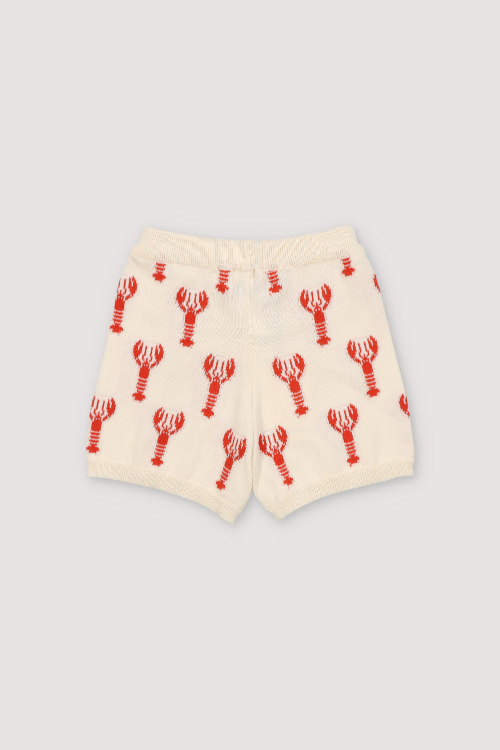 Knit shorts with a playful lobster intarsia pattern and ribbed elastic waistband. It has a matching top to create a perfect summer look. Spring Smmer Collection. The New Society.