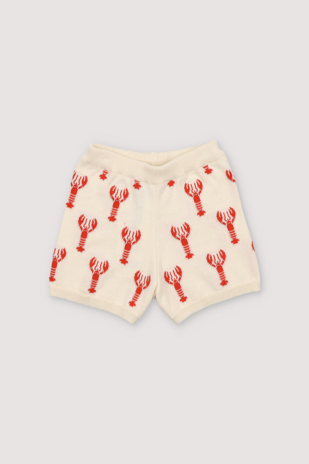 Knit shorts with a playful lobster intarsia pattern and ribbed elastic waistband. It has a matching top to create a perfect summer look. Spring Smmer Collection. The New Society.