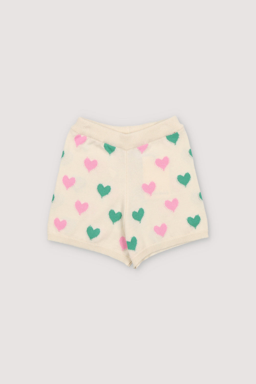 Knit shorts with a playful two-color heart intarsia pattern and ribbed elastic waistband. It has a matching top to create a perfect summer look. Spring Summer Collection. The New Society.