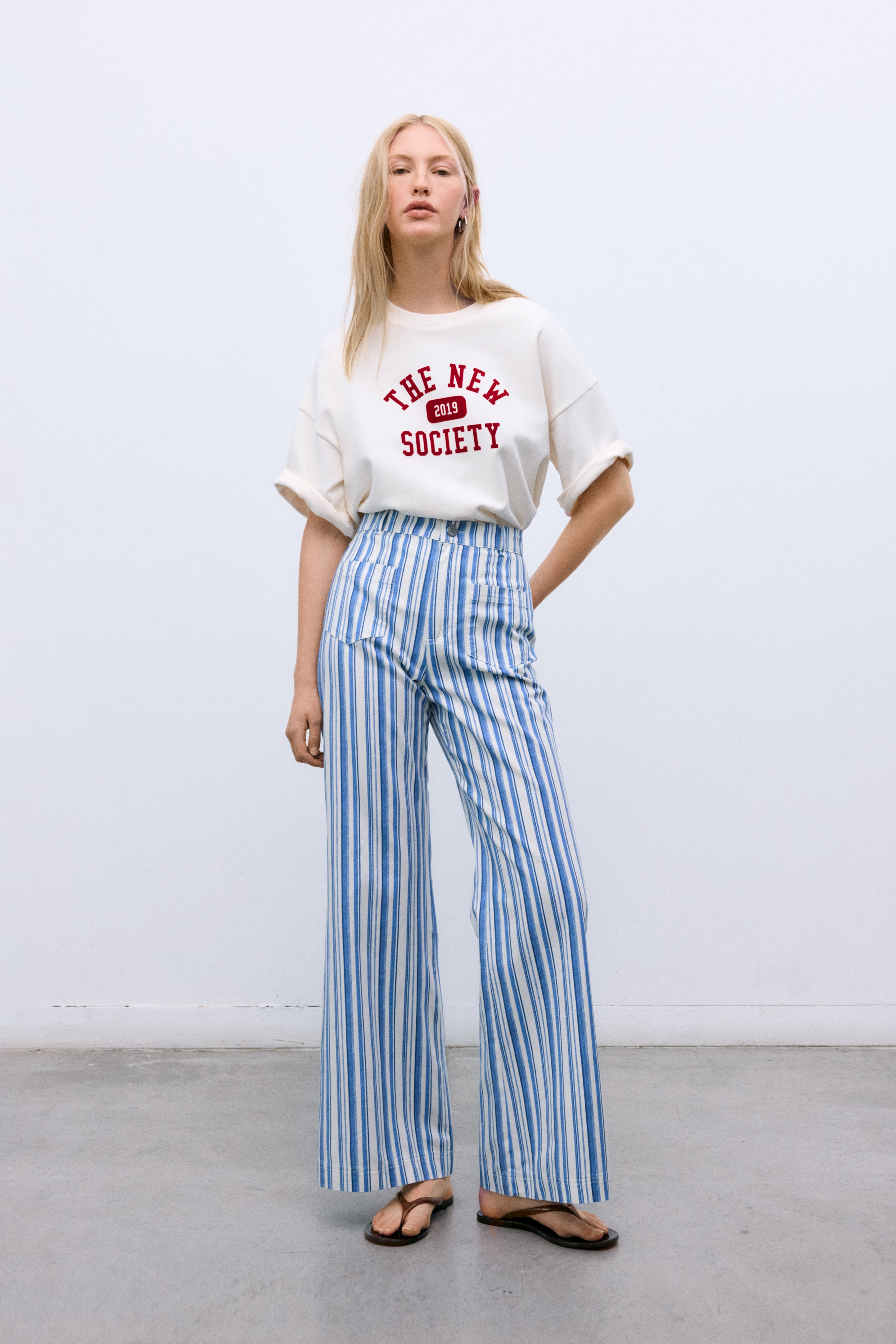 Women’s blue striped denim pants crafted with a refined contrasting stripe print that elevates a timeless silhouette.