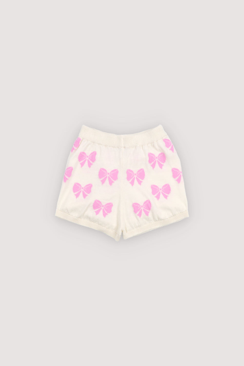 Fine 100% cotton knit shorts featuring delicate pink bows. Designed with an elastic ribbed waistband and ribbed hems for a comfortable fit.