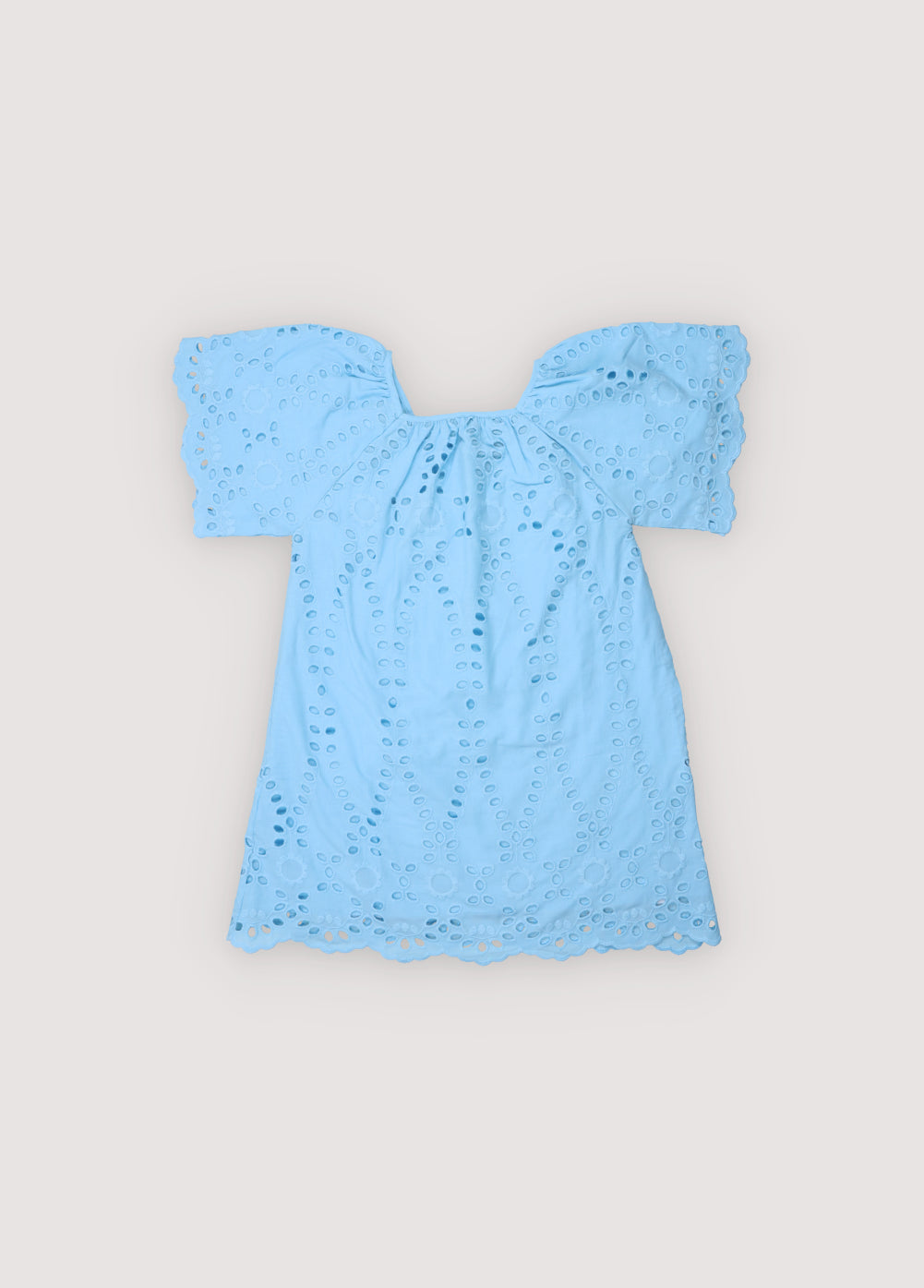 Patmos Dress in embroidered voile fabric, 100% cotton, in powder blue color. The dress features wide sleeves, gathers at the shoulders, front, and back for added volume, with embroidered fabric finishing on the sleeve cuffs and hem. Spring Summer Collection. The New Society.