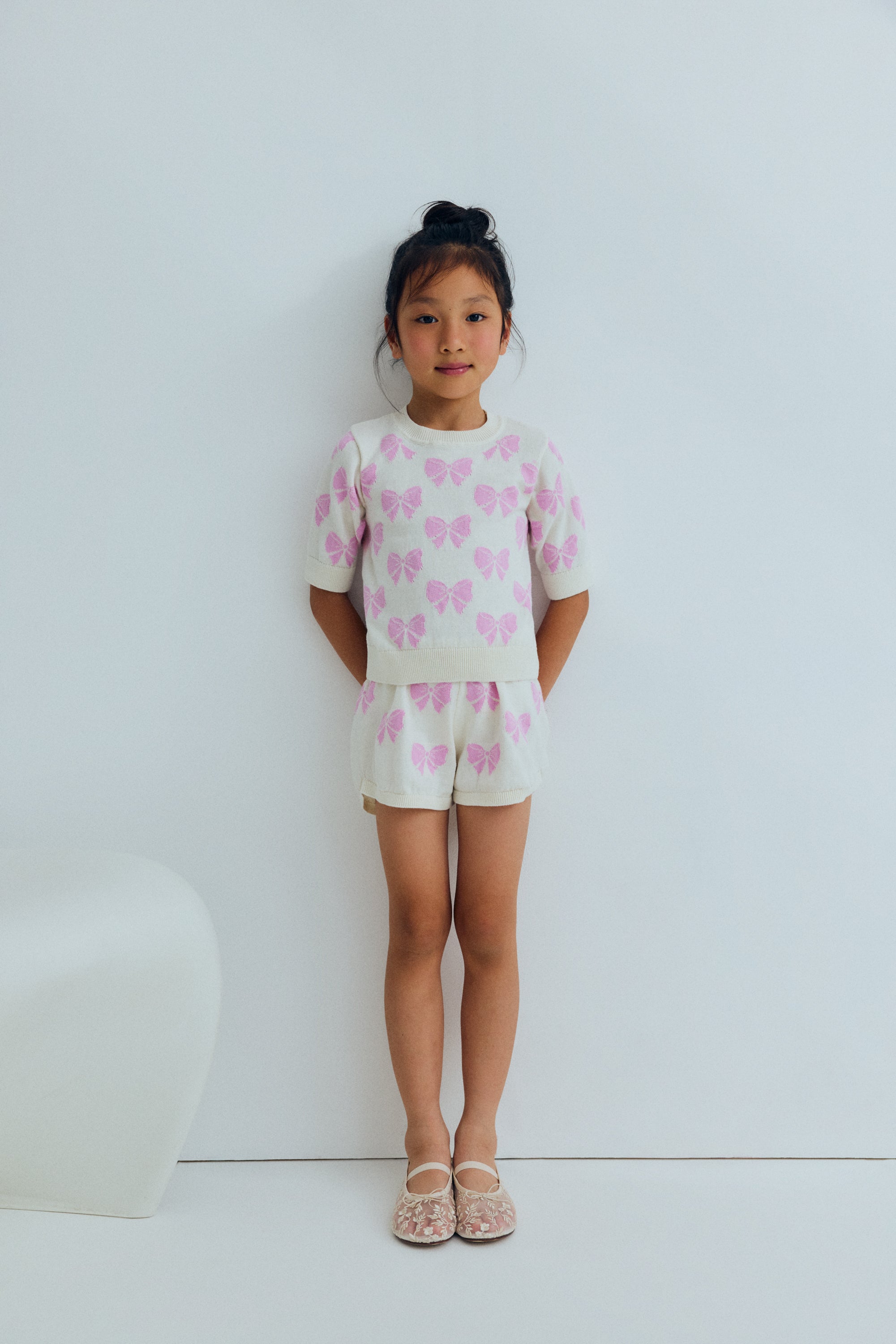 One of our bestselling sets: a fine 100% cotton knit jumper adorned with delicate pink bows and finished with ribbed hem, collar and cuffs.