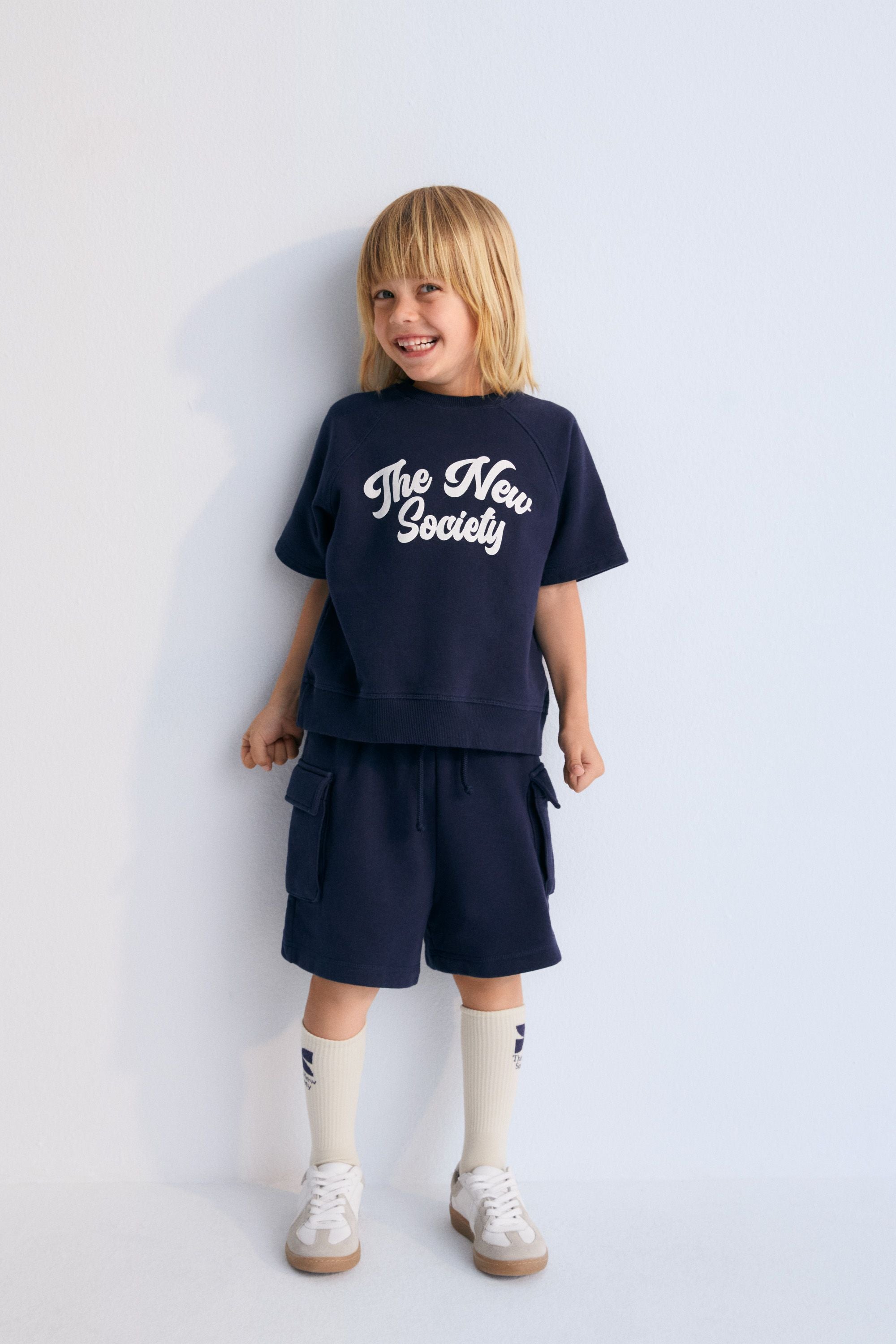 Bermuda shorts with two cargo-style pockets and an elastic waistband. Spring Summer Collection. The New Society.