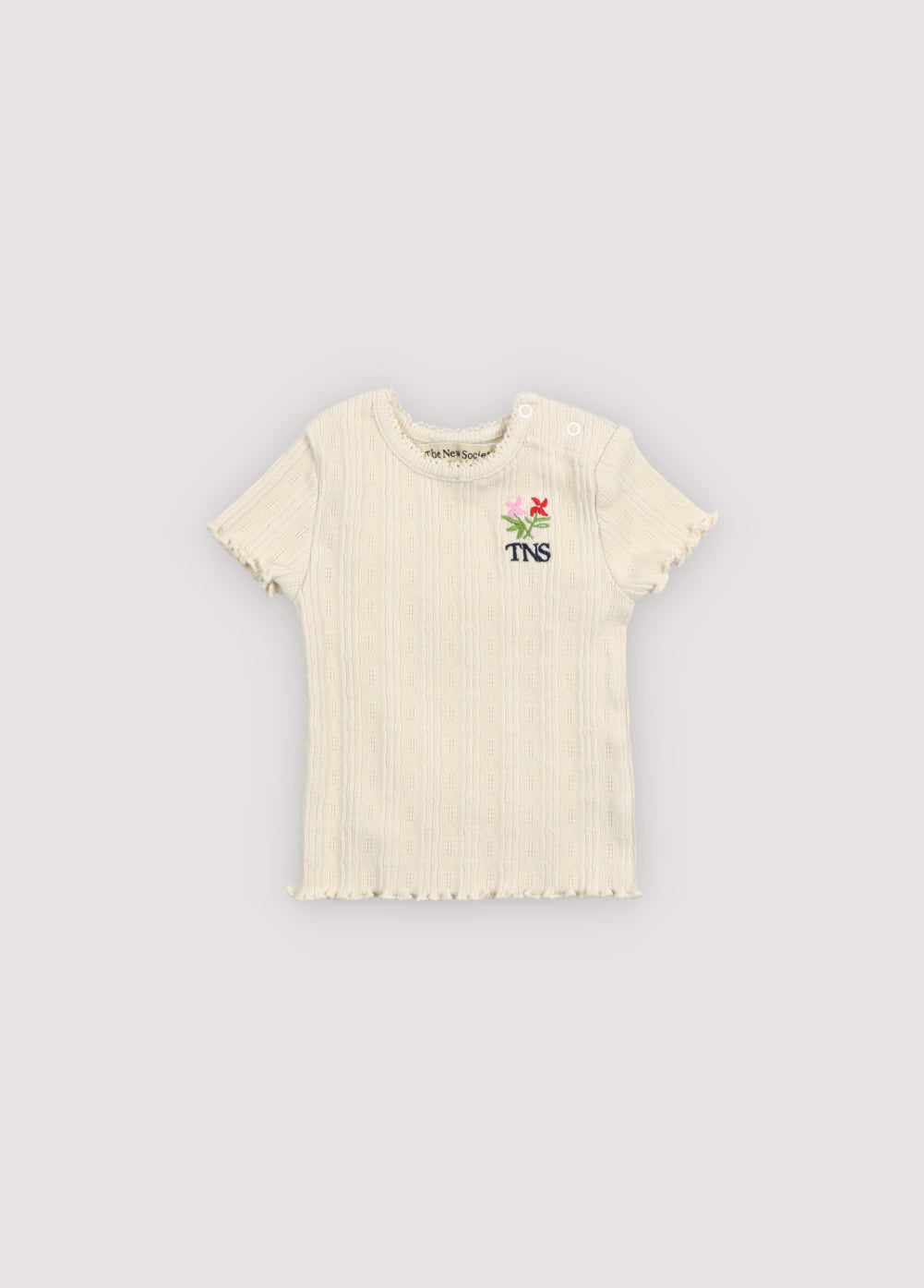 Soft cotton jersey tee featuring a delicate openwork design that adds a special touch. Finished with a round neckline, overlocked hem and cuffs, and a small floral brand embroidery on the chest.
