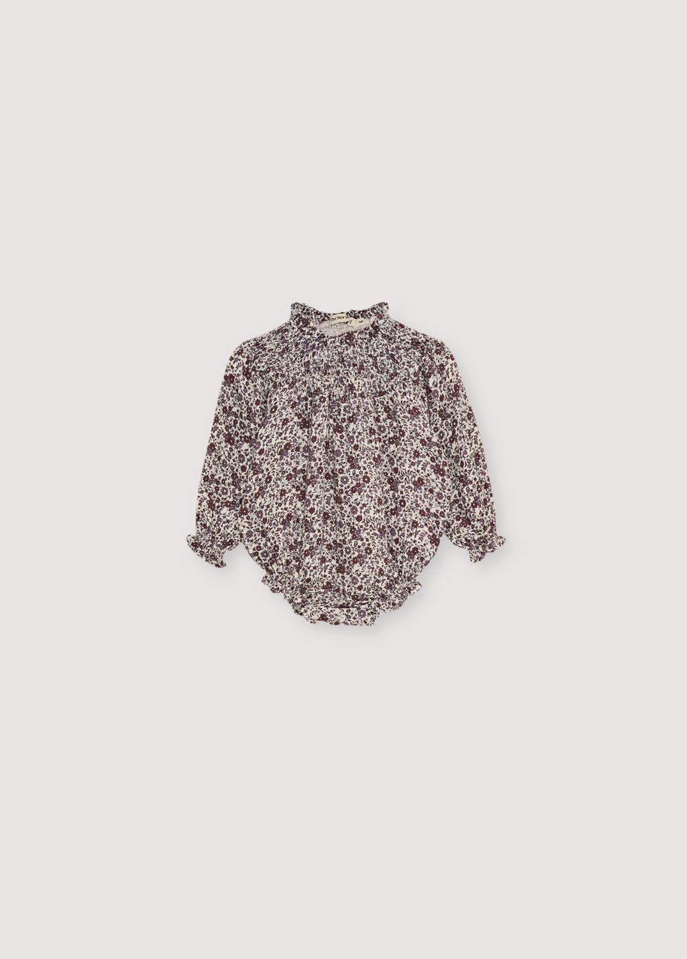 Baby romper in double gauze quality with a beautiful floral print, featuring elastic detailing at the neckline and a small ruffle trim.