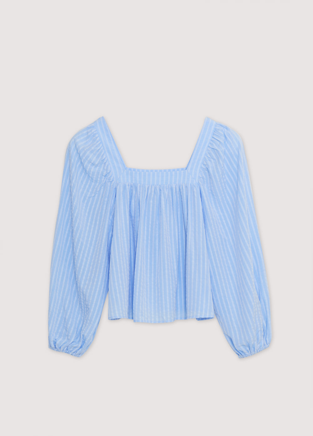 Symi Woman Blouse in 100% Tencel striped fabric. The blouse features a square neckline, gathers to create volume, and elastic cuffs.