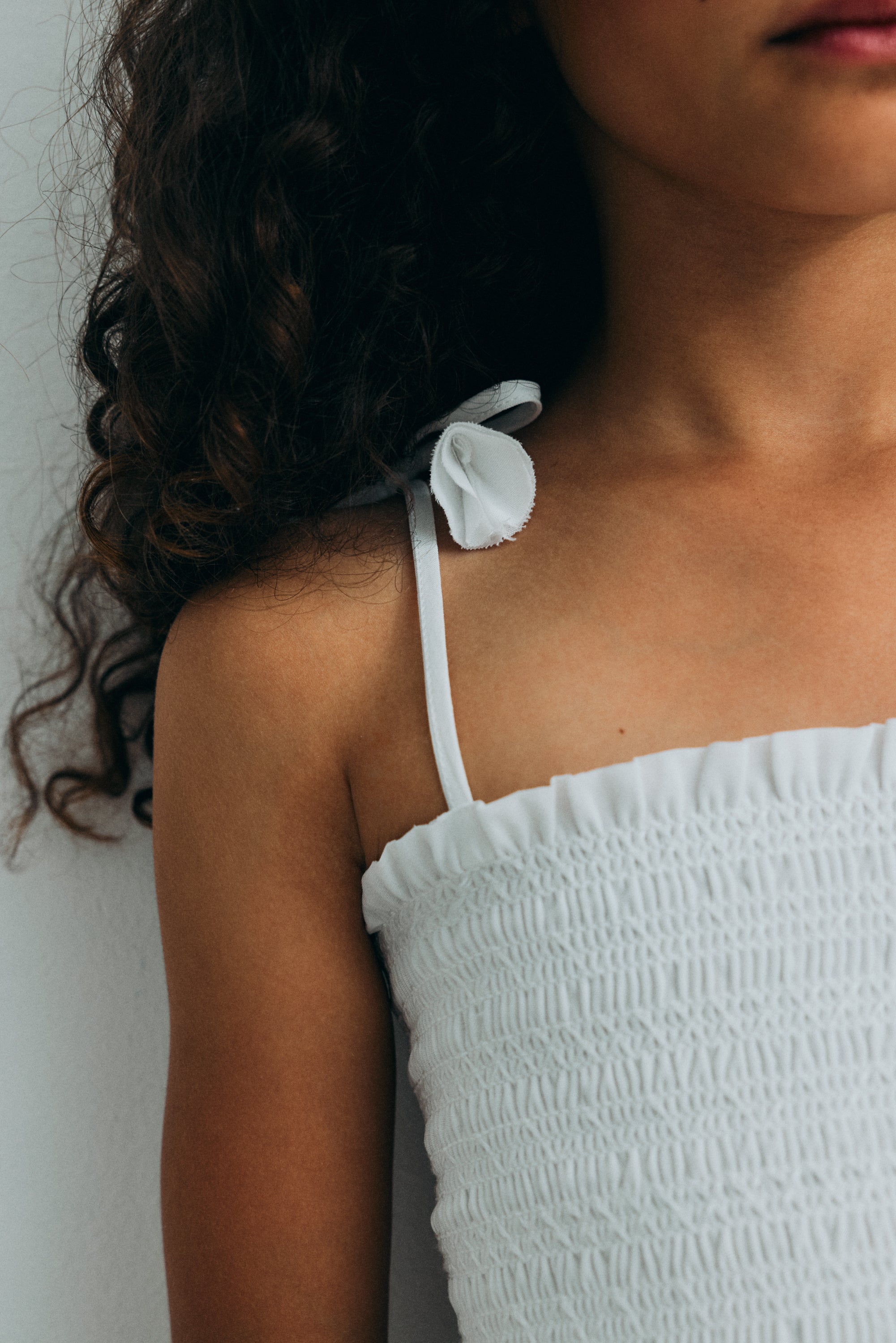 Short dress in beautiful embroidered cotton fabric, featuring a smocked bodice with ruffle detail for a comfortable and flattering fit.