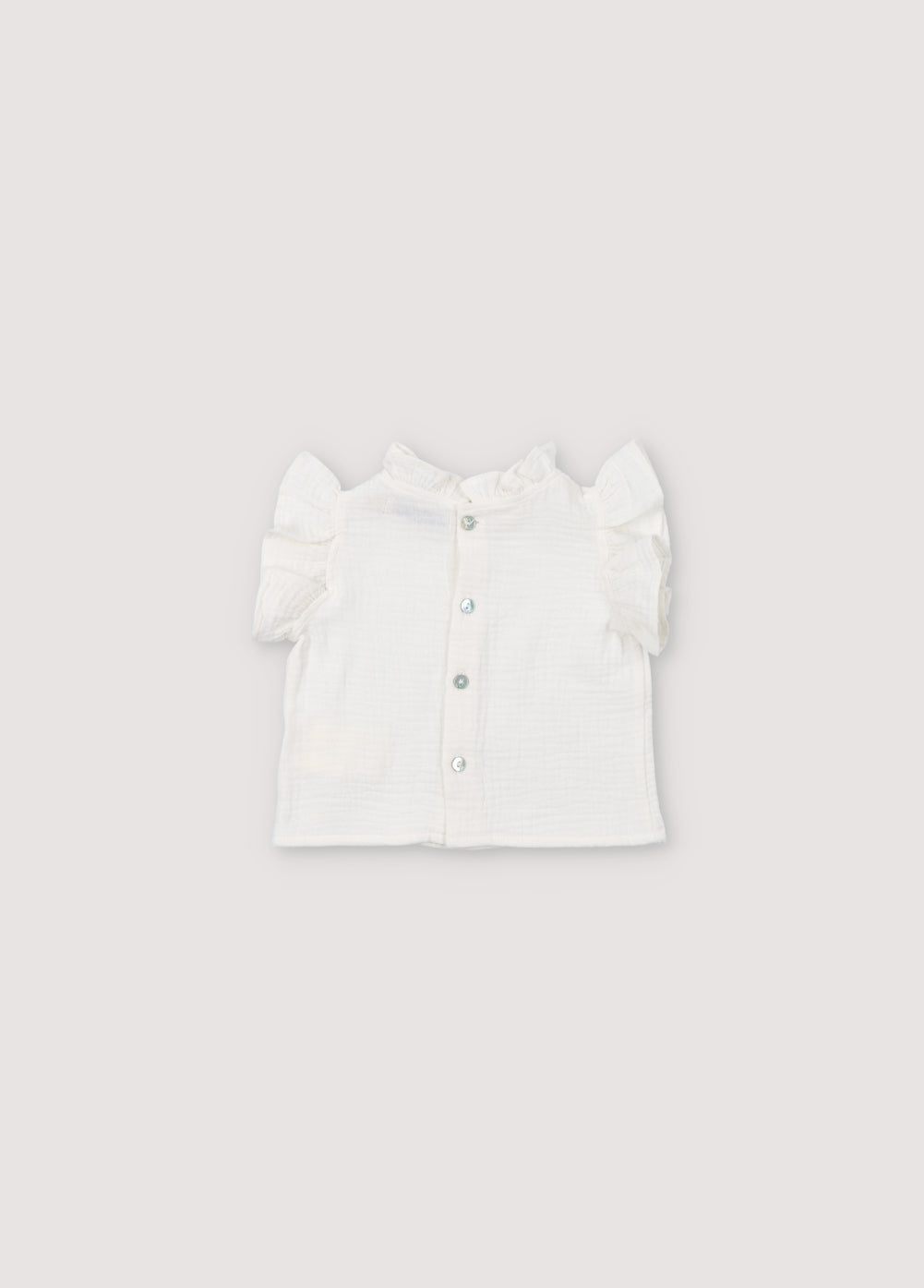Spyros Baby Blouse in 100% cotton muslin fabric in our coconut color. TNS Kids embroidery to match. Spring Summer Collection. The New Society.