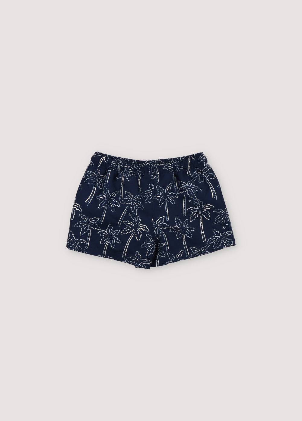 Swimsuit with contrast palm tree print on a navy background, featuring an elastic waistband with an adjustable drawstring. Spring Summer Collection. The New Society.