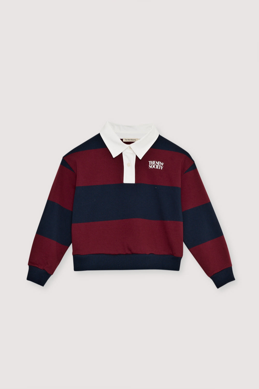 Bicolor striped crop polo with a contrasting collar in twill fabric. It features a contrasting print on the chest.