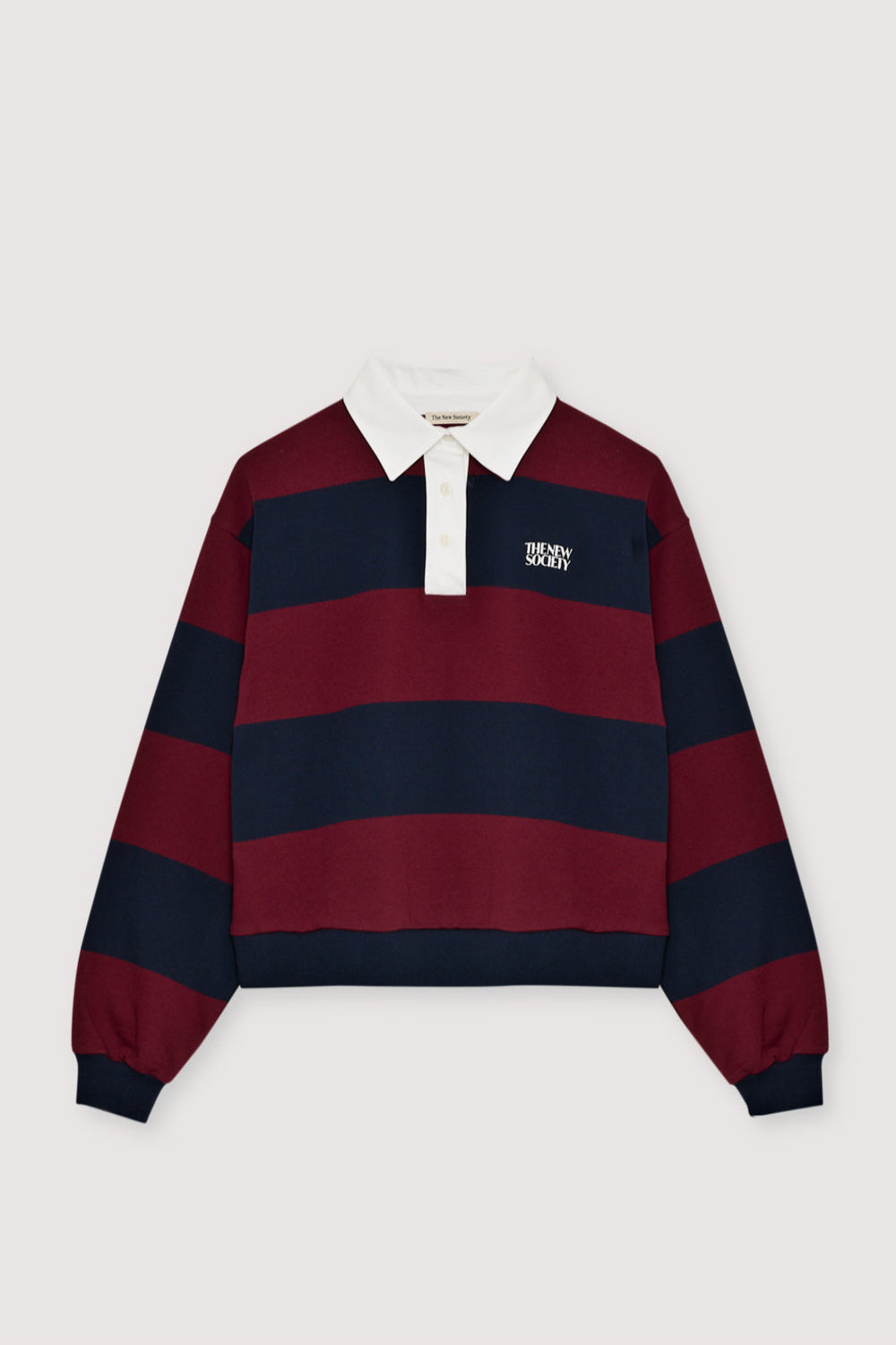 Bicolor striped crop polo with a contrasting collar in twill fabric. It features a contrasting print on the chest.