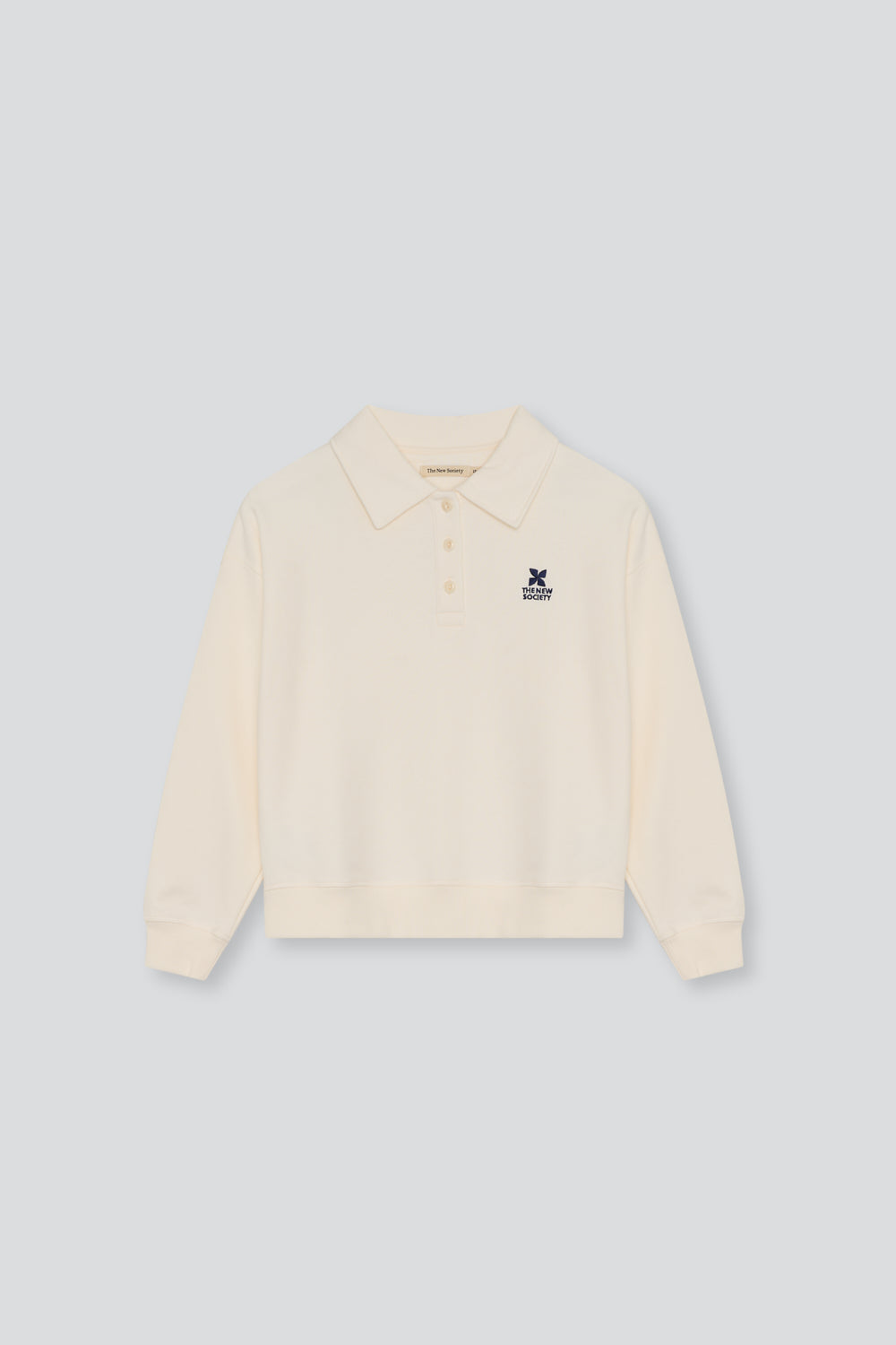 Soft cotton fleece polo featuring ribbed cuffs and hem, a tonal buttoned opening at the neck, and branded embroidery on the chest