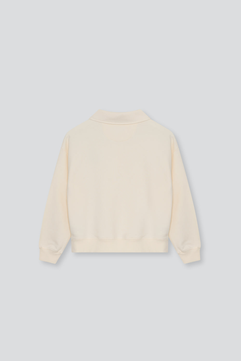 Soft cotton fleece polo featuring ribbed cuffs and hem, a tonal buttoned opening at the neck, and branded embroidery on the chest