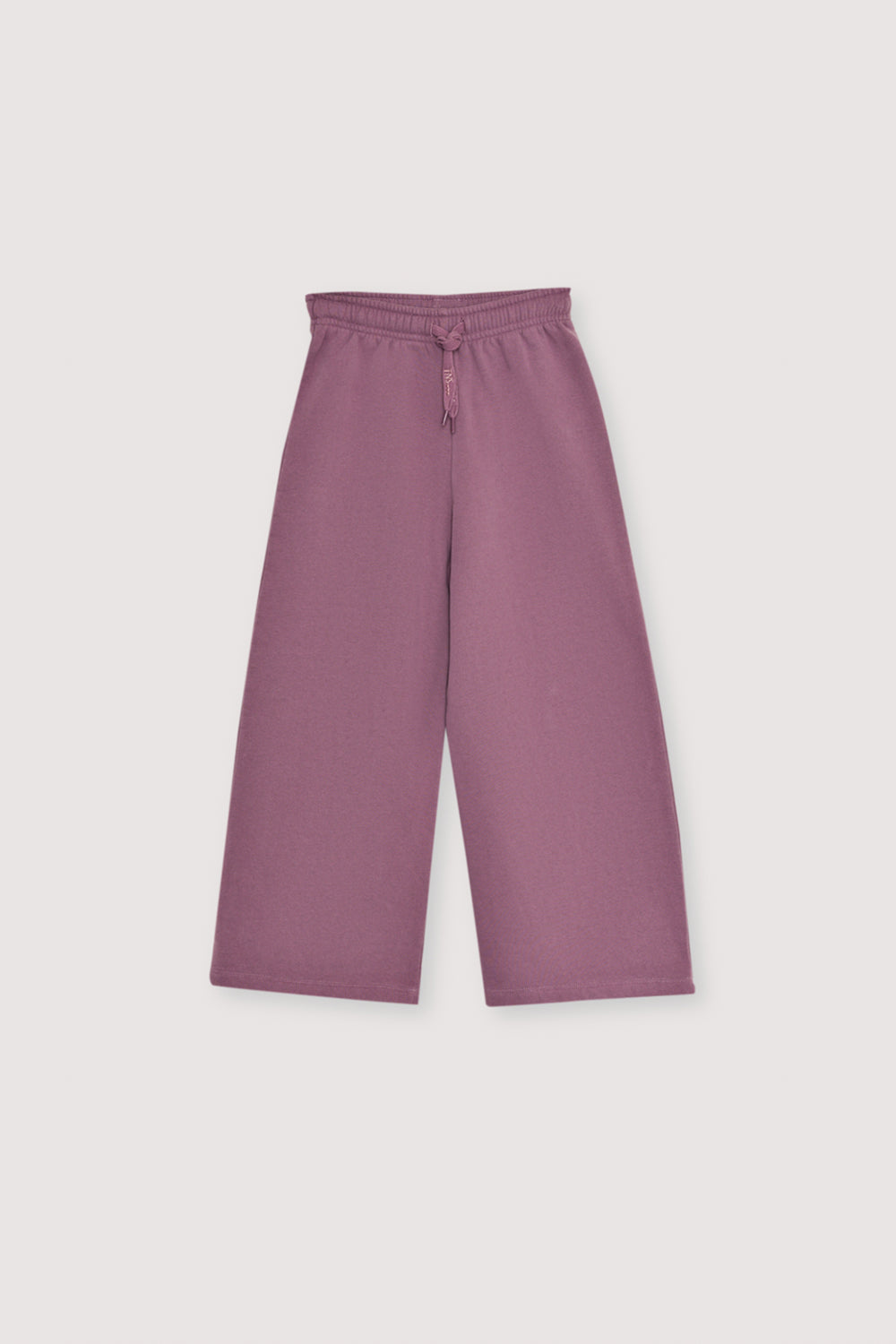 Fleece joggers brushed inside and outside with a wide-leg fit and an elastic, adjustable waistband with a drawstring. Brushed on the inside and outside. It has an embroidery detail on lurex cord.