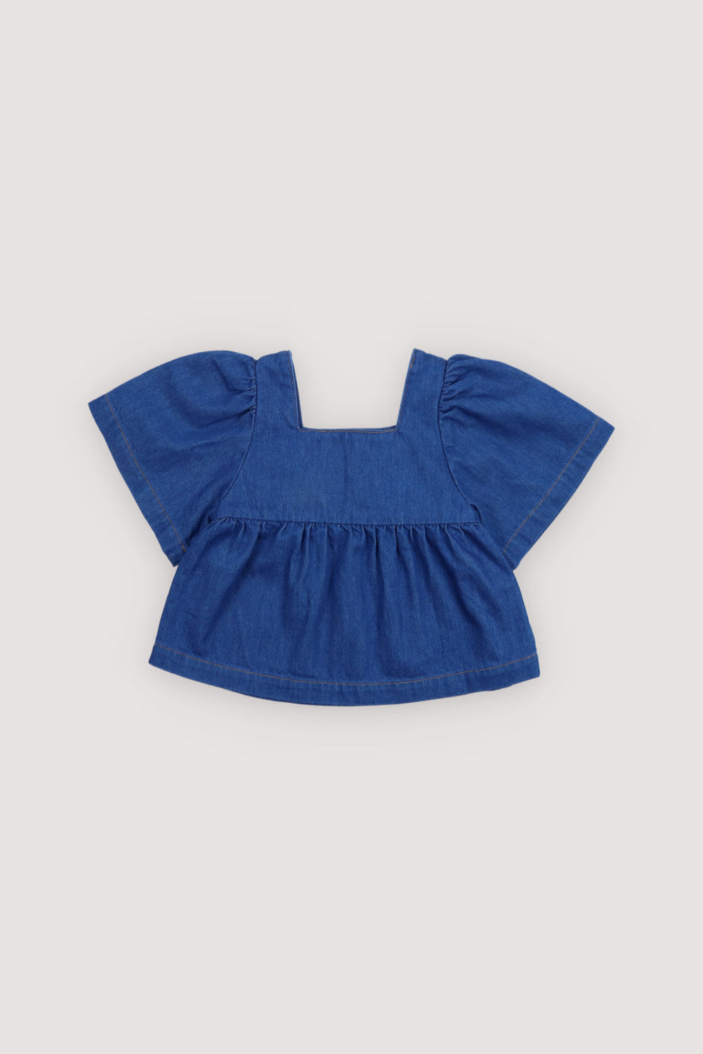 Cotton denim blouse with a square neckline and chest seam detail, featuring short puff sleeves that add volume and charm.