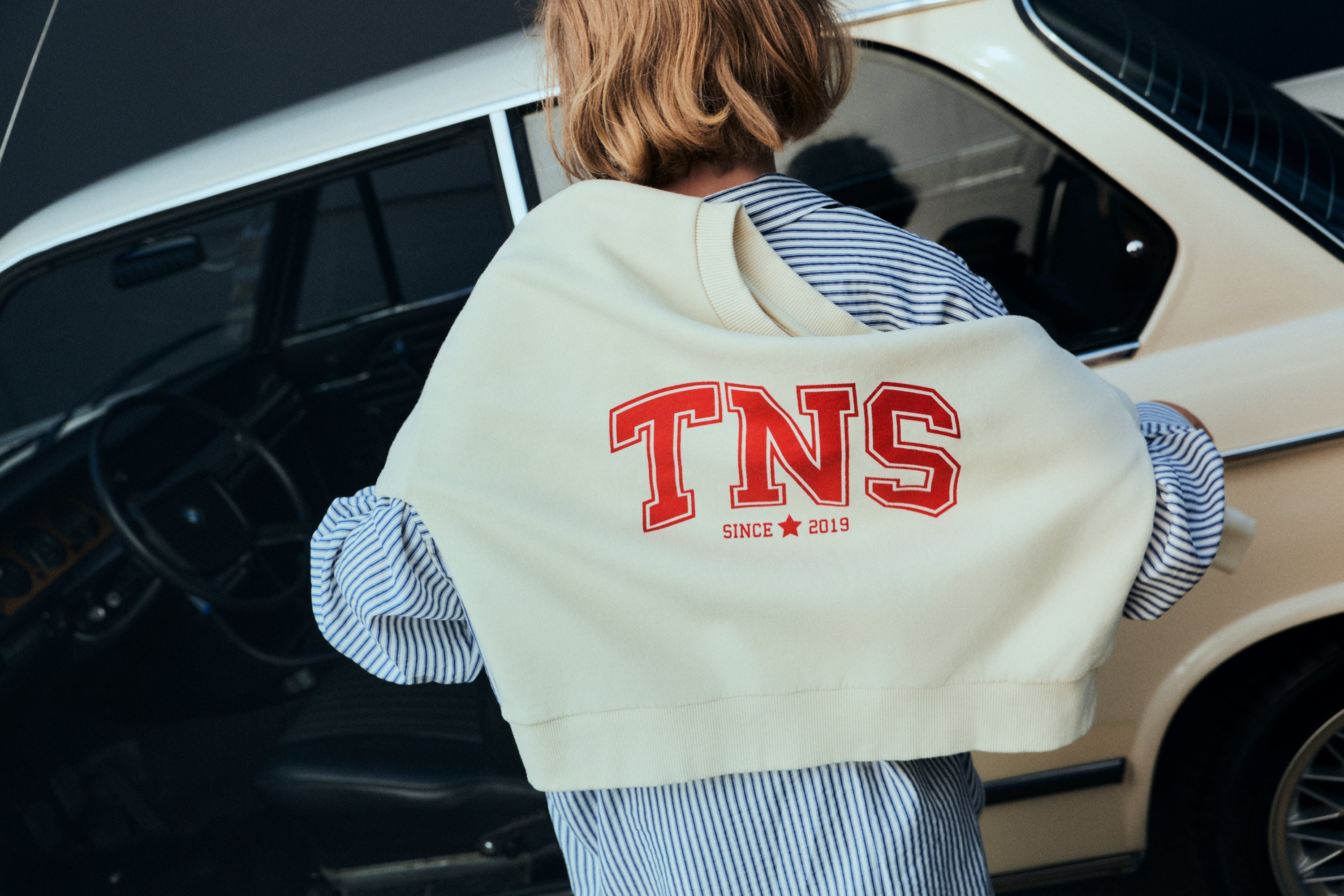 Crop sweatshirt in soft cotton fleece with ribbed collar and cuffs, featuring a contrasting TNS embroidery on the chest for a cozy yet stylish look.