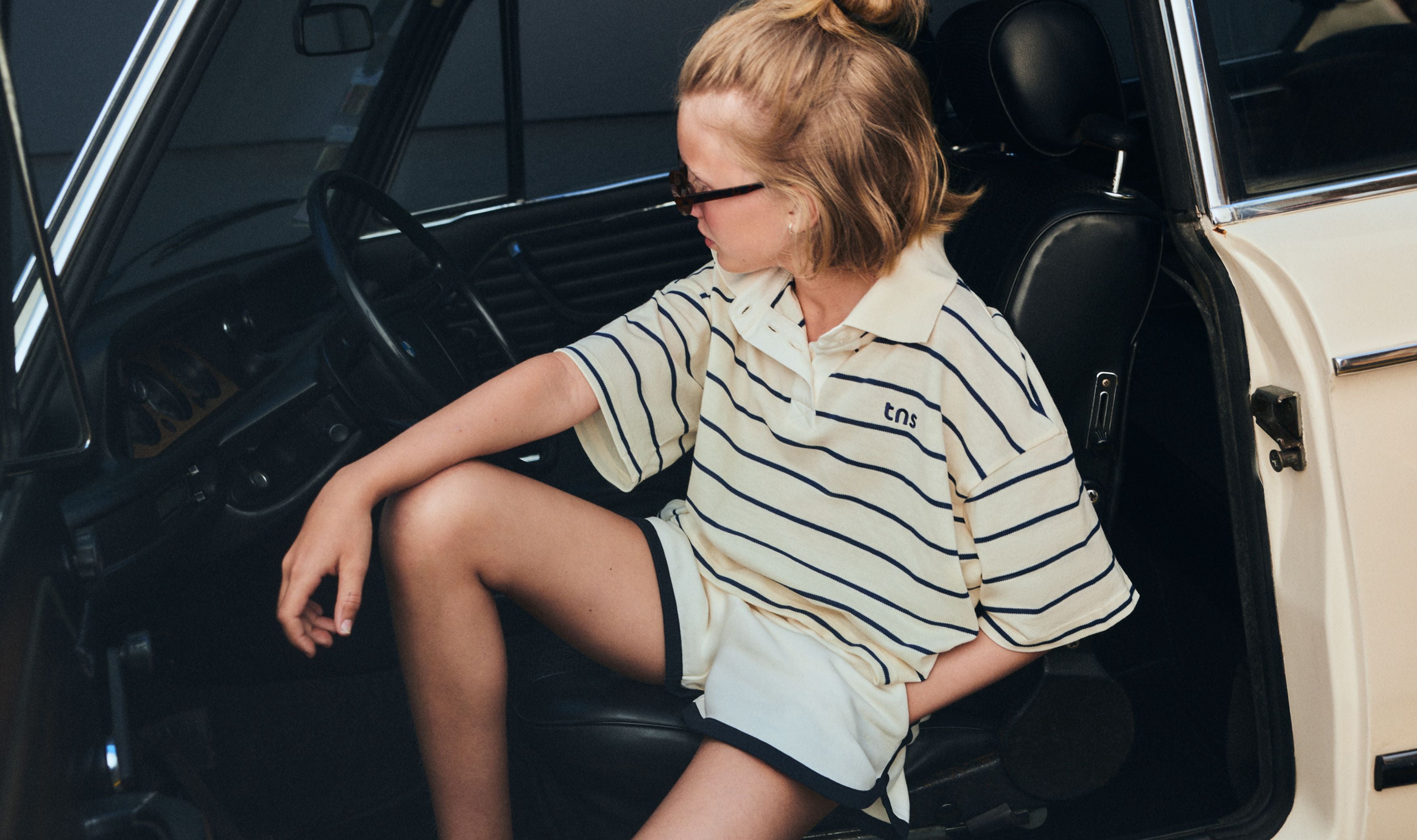 Cropped polo crafted in soft piqué fabric, featuring contrasting stripes and a structured twill collar.