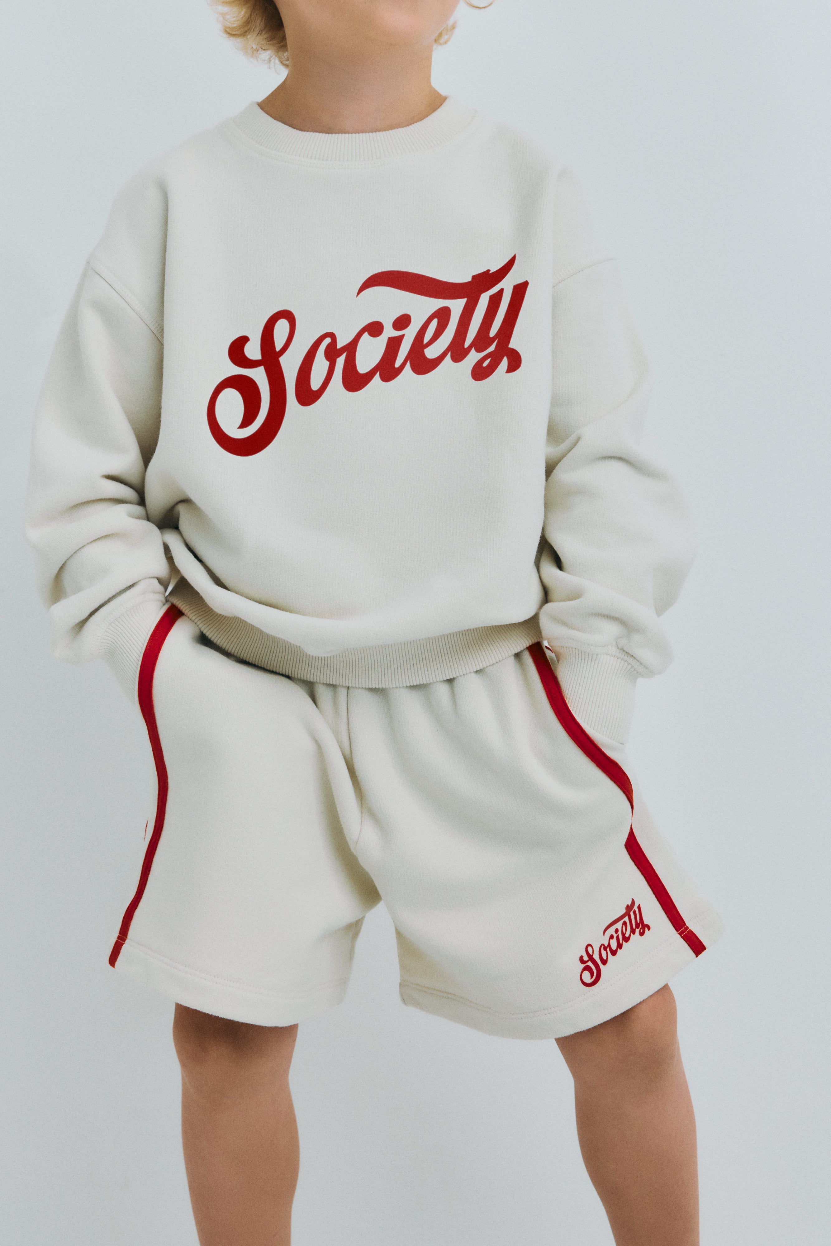 Soft cotton terry bermuda shorts featuring an elastic waistband, side pockets, double contrasting side stripes, and a brand print on the hem for a sporty, stylish finish.