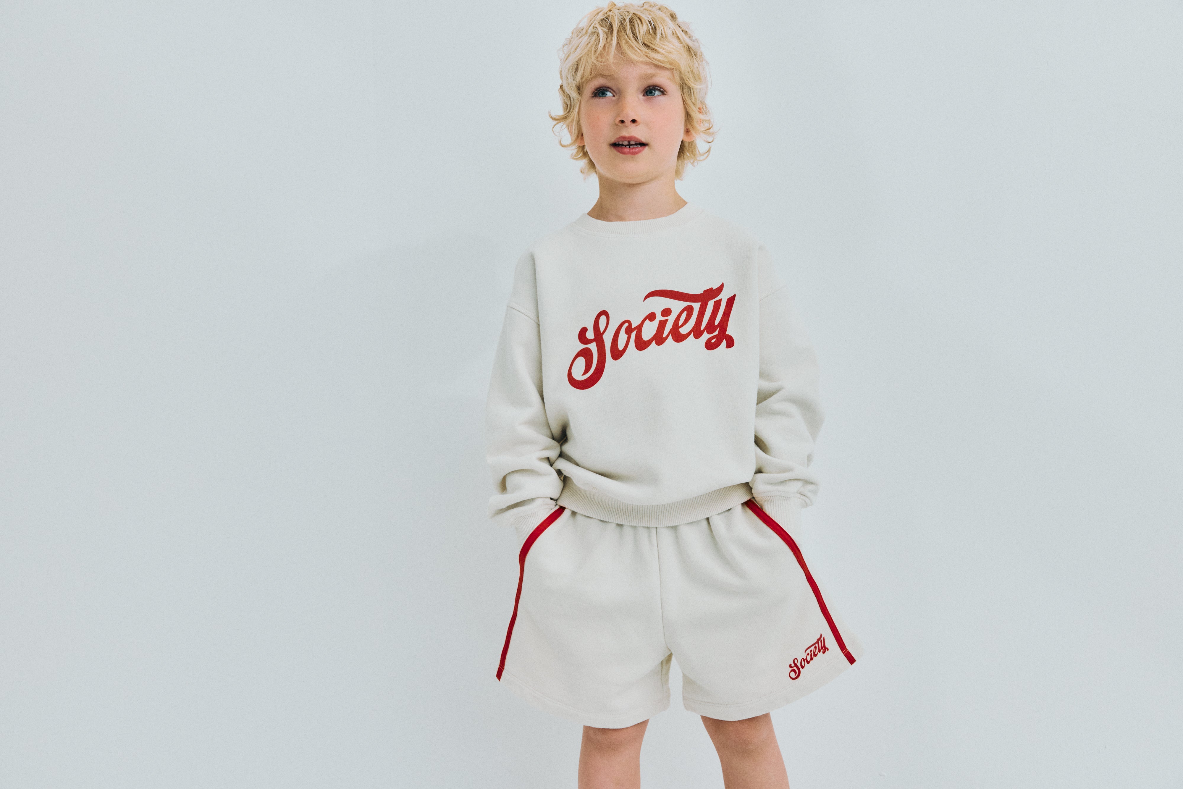 Soft cotton terry bermuda shorts featuring an elastic waistband, side pockets, double contrasting side stripes, and a brand print on the hem for a sporty, stylish finish.