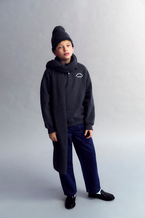 Fleece polo with a tone-on-tone brand print detail on the chest.