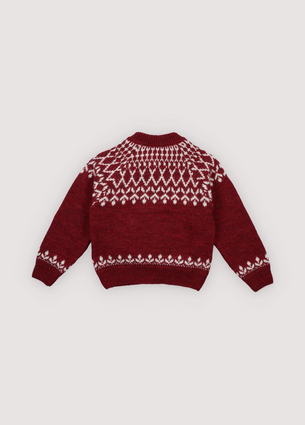 A cozy knitted cardigan in a festive plum color, featuring a charming white pattern across the chest, sleeves, and hem. Soft, warm, and gently stretchy, it keeps little ones comfortable all day. Designed with a front button closure and a relaxed fit, it’s perfect for easy dressing and playful movement. Ideal for holiday gatherings or capturing seasonal memories in style.