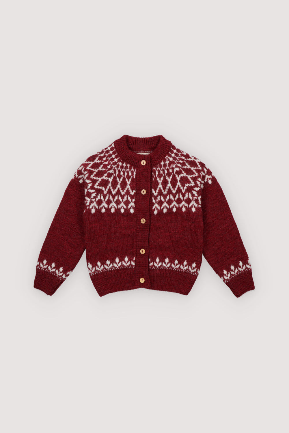 A cozy knitted cardigan in a festive plum color, featuring a charming white pattern across the chest, sleeves, and hem. Soft, warm, and gently stretchy, it keeps little ones comfortable all day. Designed with a front button closure and a relaxed fit, it’s perfect for easy dressing and playful movement. Ideal for holiday gatherings or capturing seasonal memories in style.