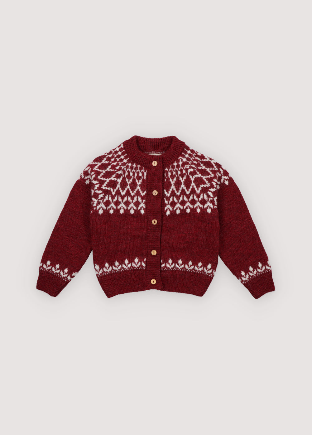 A cozy knitted cardigan in a festive plum color, featuring a charming white pattern across the chest, sleeves, and hem. Soft, warm, and gently stretchy, it keeps little ones comfortable all day. Designed with a front button closure and a relaxed fit, it’s perfect for easy dressing and playful movement. Ideal for holiday gatherings or capturing seasonal memories in style.