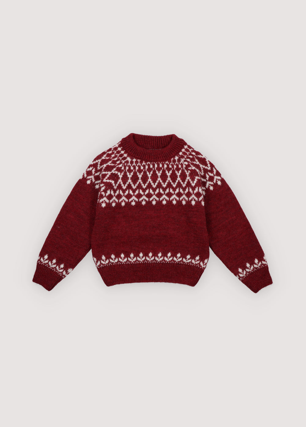 A cozy knitted jumper in a festive plum color, featuring a charming white pattern across the chest, sleeves, and hem. Soft, warm, and gently stretchy, it keeps little ones comfortable all day. With a relaxed fit for easy movement, it’s perfect for layering over shirts or dresses and ideal for holiday gatherings or capturing seasonal memories in style.