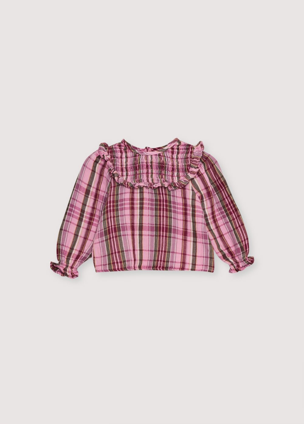 Blouse bébé en double gaze à carreaux avec empiècement smocké et détail volant. Il présente une ouverture au dos avec une patte et des boutons. Parfait à associer avec le bloomer assorti.